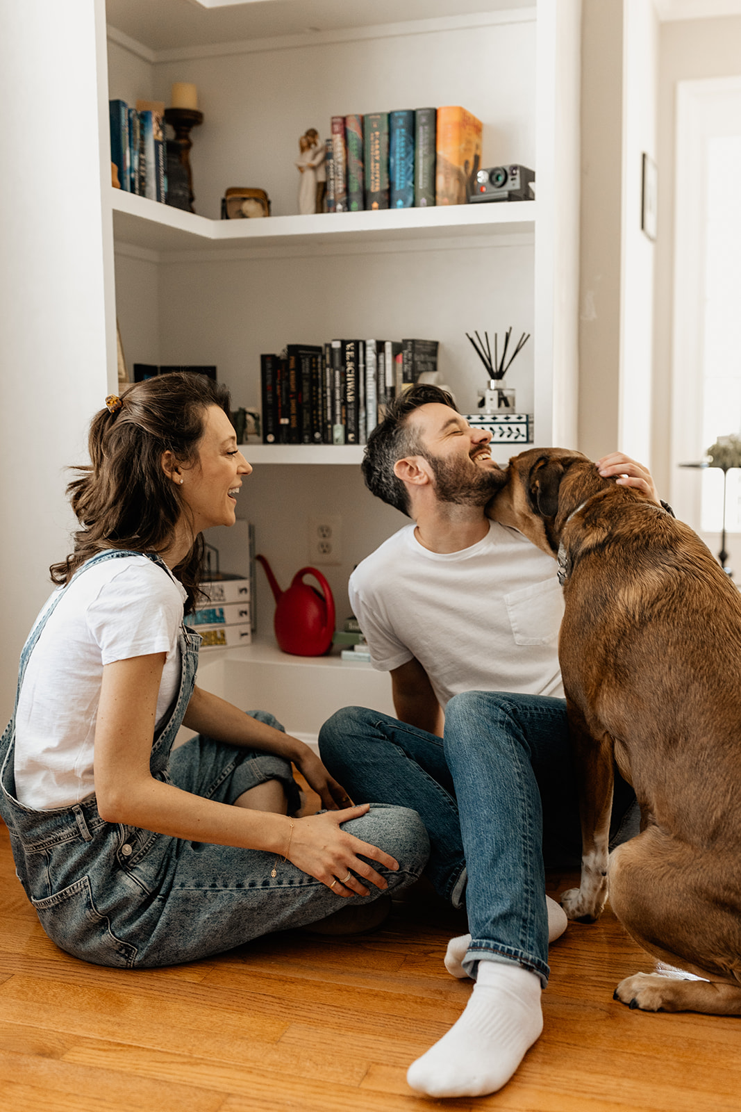 couple siting in corner with dog